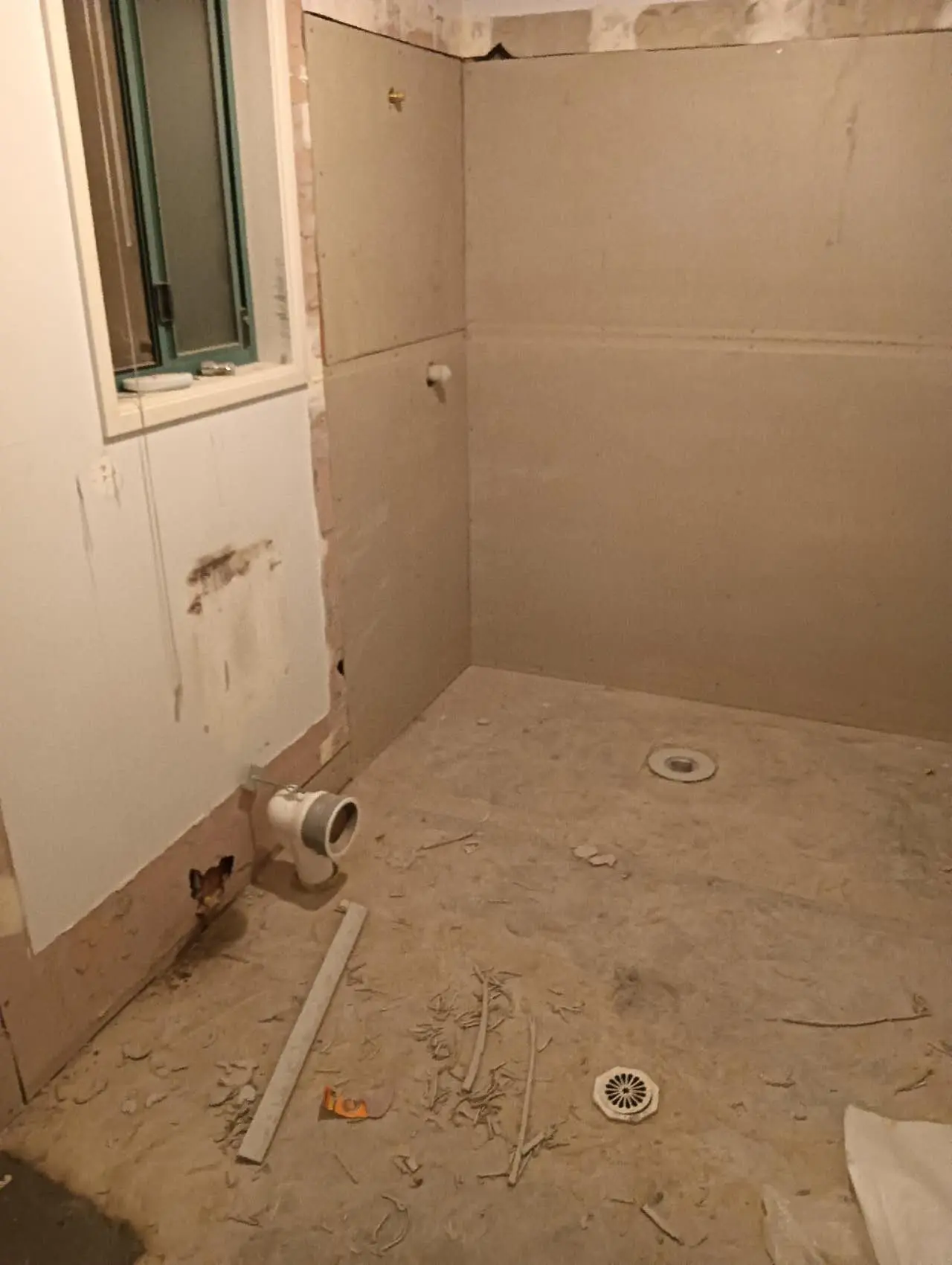 Bathroom wall sheeting and floor substrate prepared before waterproofing
